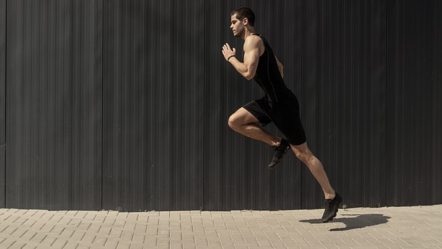 side view shot fit young athletic man jumping running