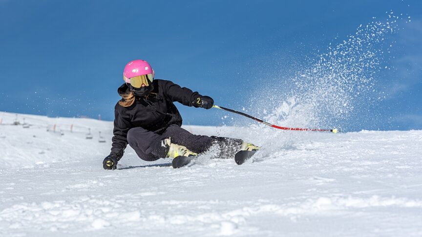 young blonde woman skiing sunny day