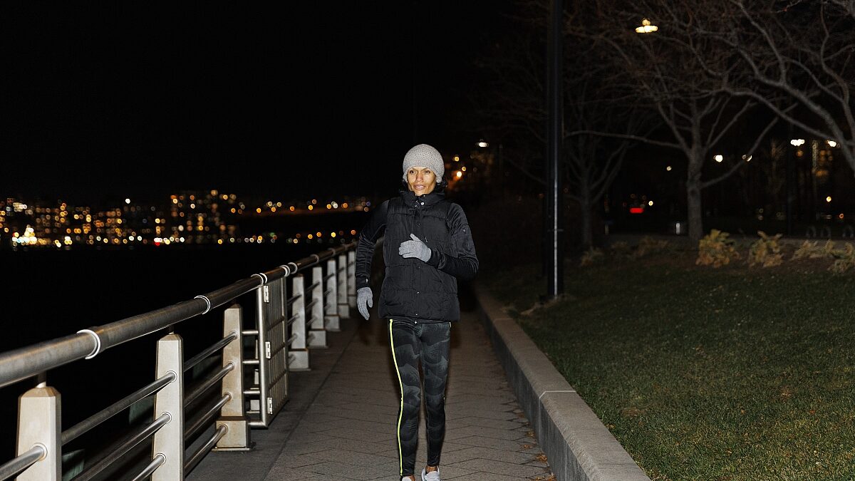 woman running night city