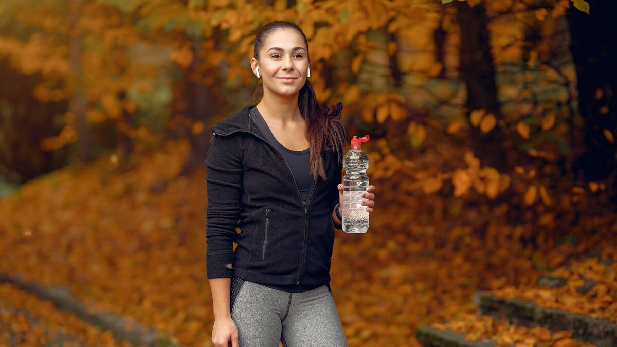 dziewczyna sportowa w czarnym top szkolenia w parku jesienia