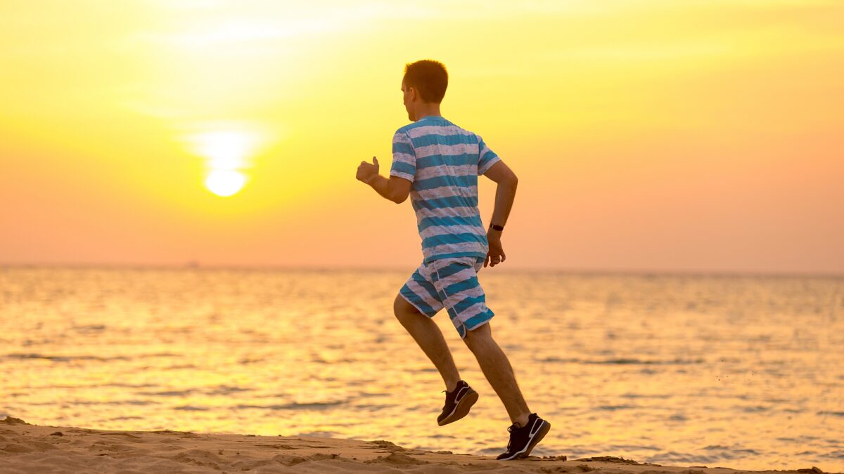 young man jogging sea coast