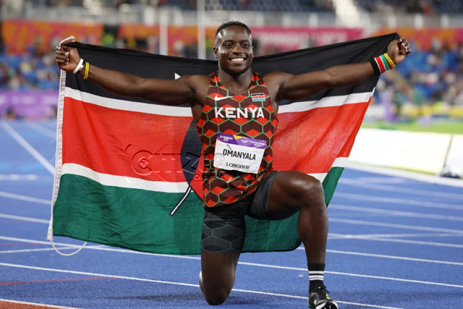 Sprinter Ferdinand Omanyala celebrates with the Kenyan sprinter Ferdinand Omanyala celebrates with the flag after winning Gold in 100m final at Commonwelath Games og image