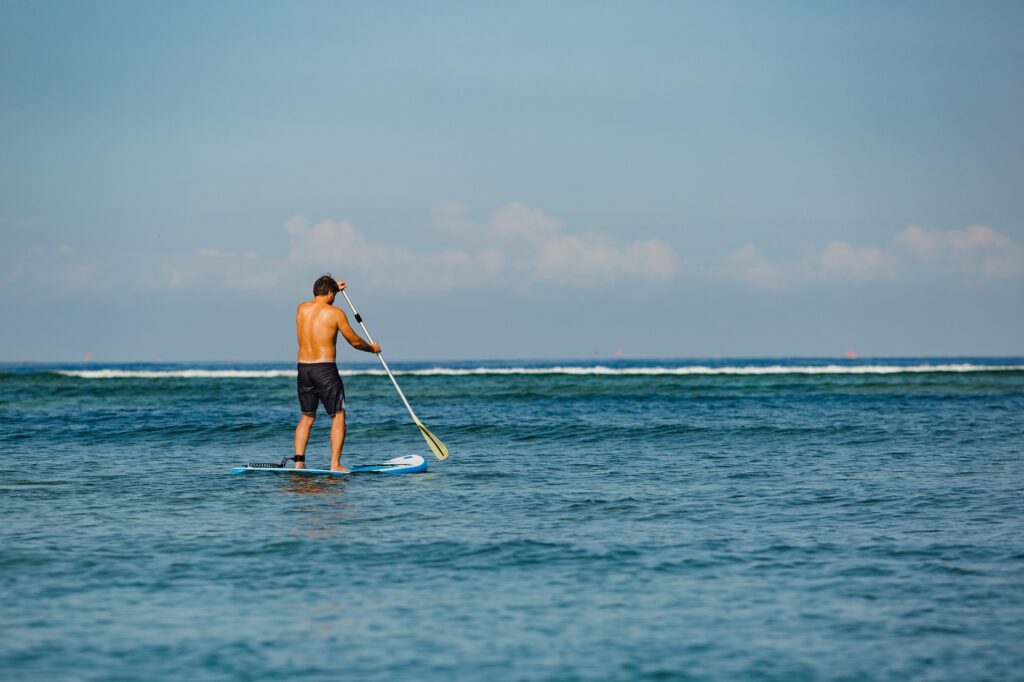 man riding sup